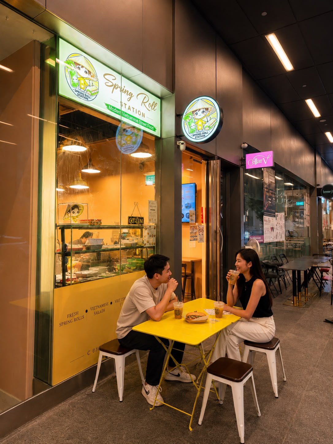 Spring Roll Station outlet with guests enjoying bánh mì and coffee